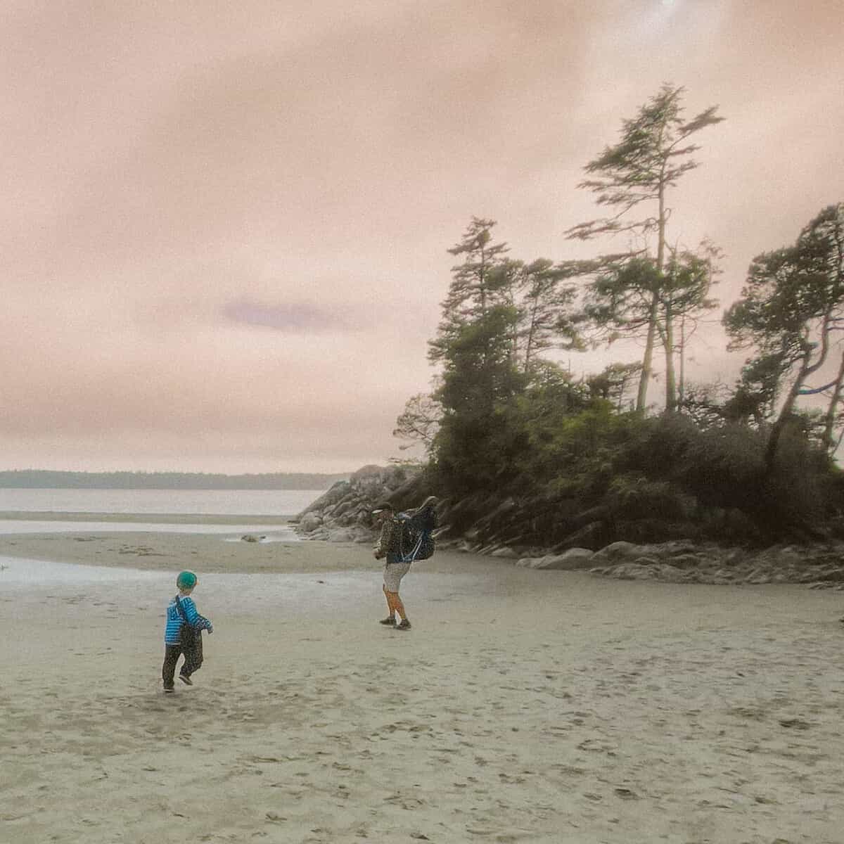 A child running along the sand at low tide at Tonquin Beach Tofino